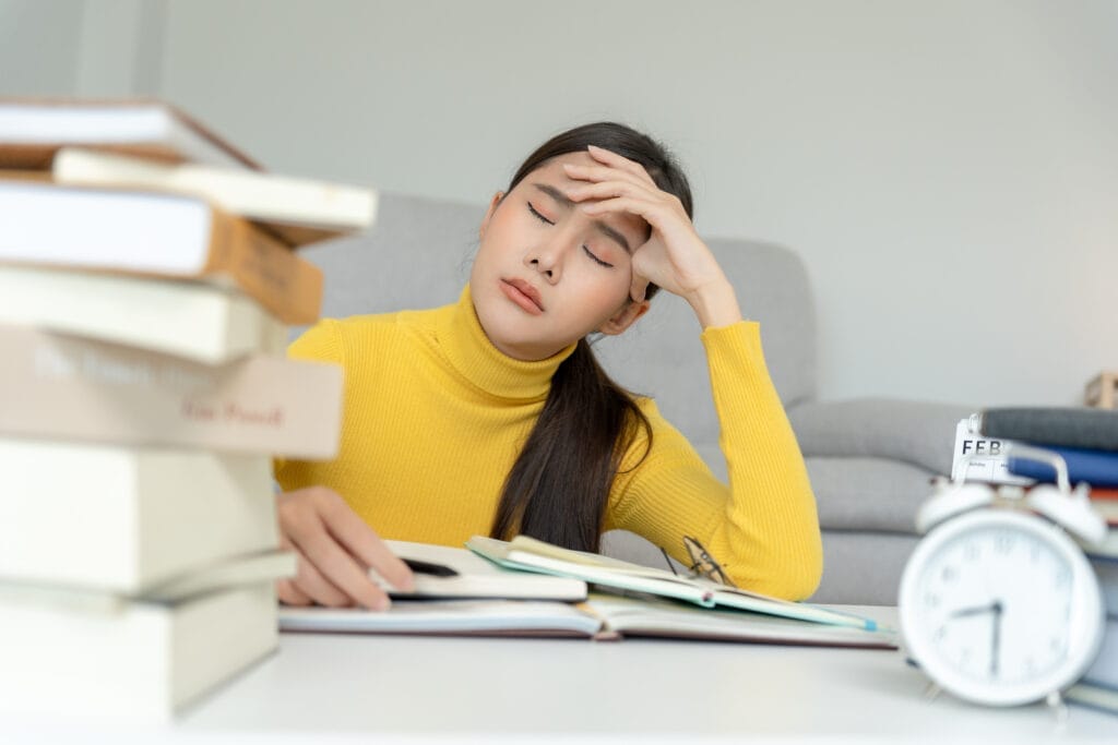Asian student woman have anxiety because of exams, female prepare for test and learning lessons in the library. stress, despair, haste, misunderstanding reading, discouraged, expectation, knowledge